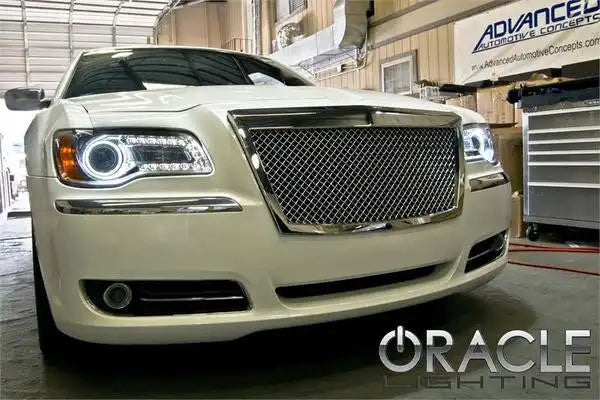 Front end of a Chysler with white LED headlight halo rings installed.