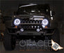 Front end of a Jeep Wrangler with white LED headlight halo rings installed.