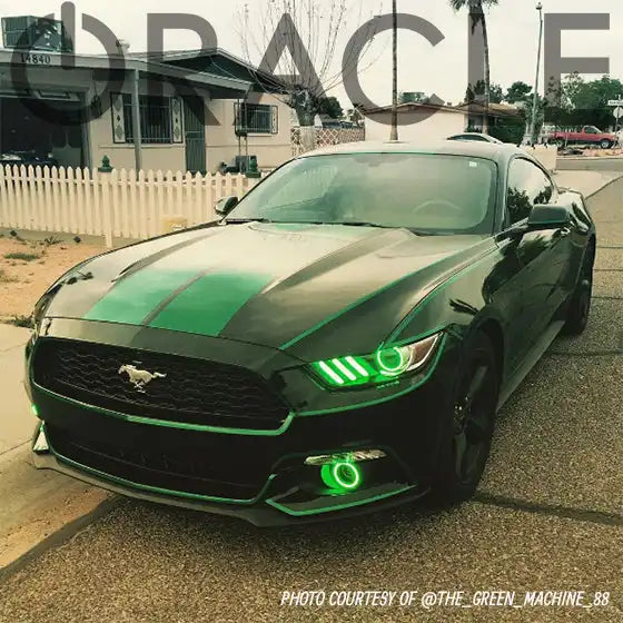 Three quarters view of a black Ford Mustang with green headlight and fog light DRLs.