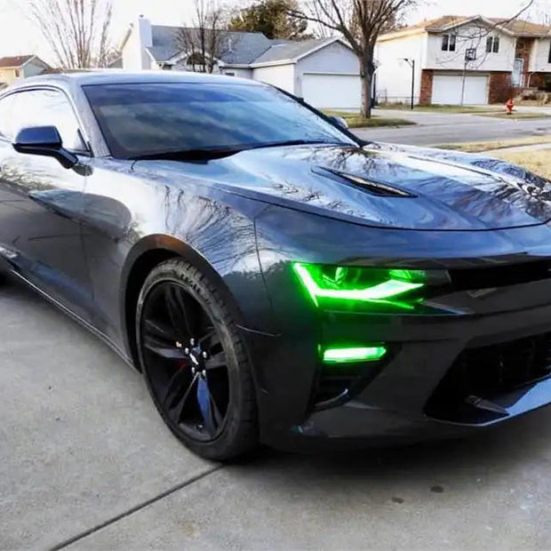 Black camaro in driveway with green DRLs.