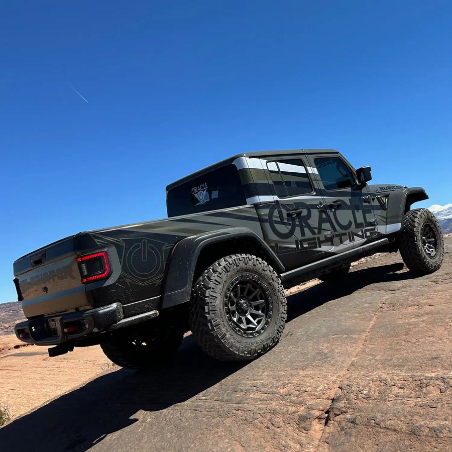Rear three quarters view of a Jeep Gladiator JT riding on a trail with Flush Mount LED Tail Lights installed.