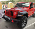 Red jeep in parking lot with bright red halos