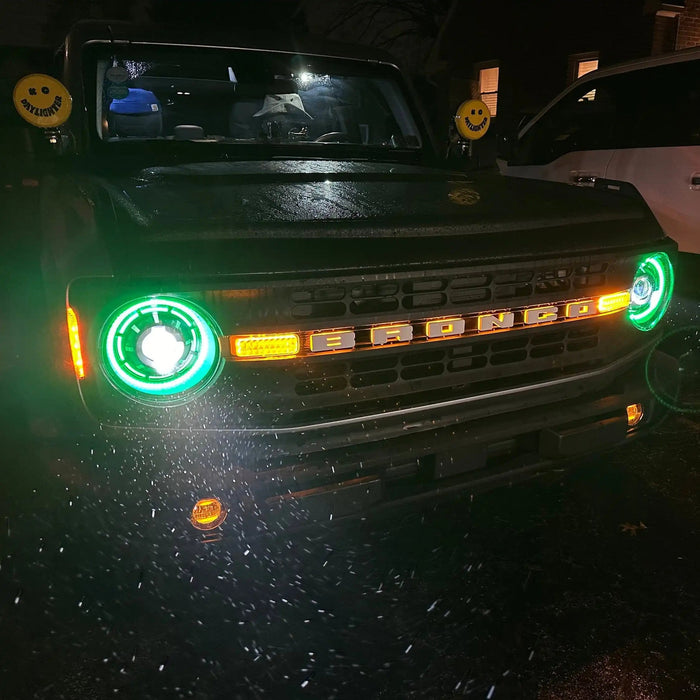 Ford Bronco outside in the rain with Oculus™ ColorSHIFT® Bi-LED Projector Headlights installed and turned on with green halos