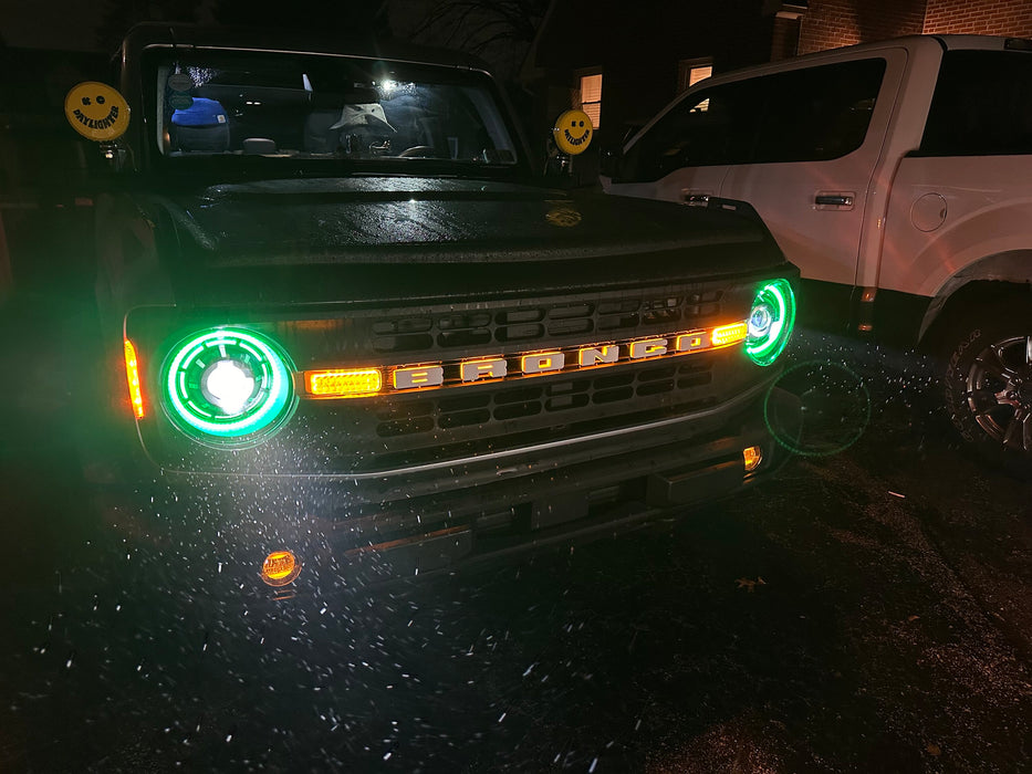 Ford Bronco outside in the rain with Oculus™ ColorSHIFT® Bi-LED Projector Headlights installed and turned on with green halos
