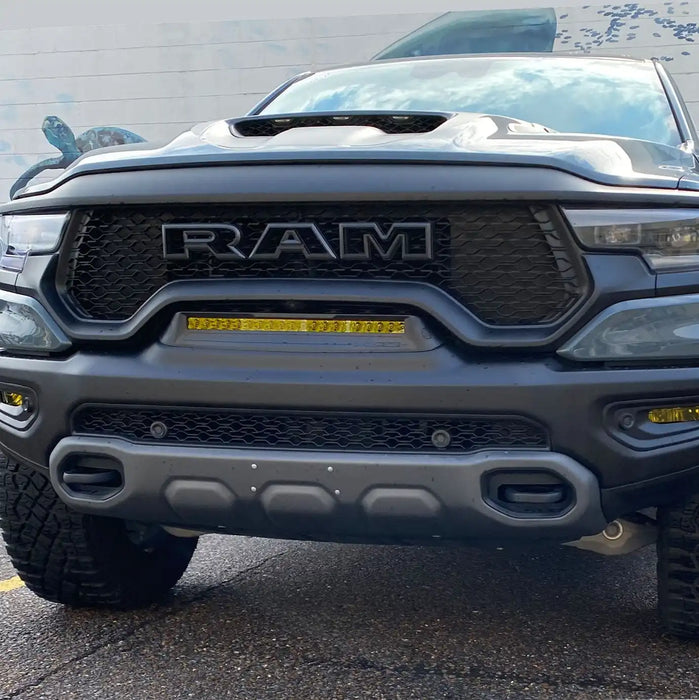 Front end of a RAM TRX with Front Bumper Flush LED Light Bar System installed with yellow LEDs.