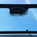 Close-up of a car's sunshade with a blue sky background
