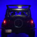 Rear view of Ford Bronco with trunk open and cargo light on.