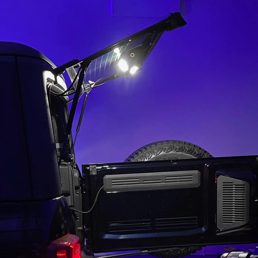 Truck bed with solar panel and lights against a purple background