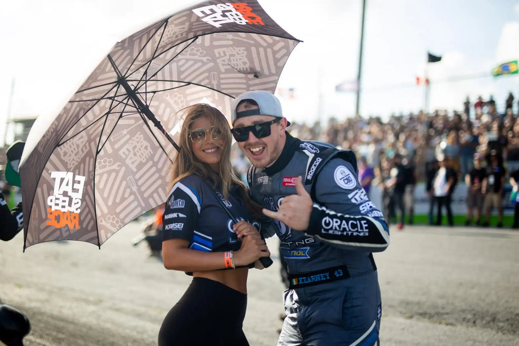 Man and a woman wearing the ORACLE Lighting Official Snap-Back Hat.