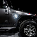 Side view of a Jeep Wrangler JK equipped with Sidetrack™ LED Fender Lighting System, with white LEDs.