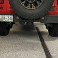Close-up on the bumper of a Jeep Wrangler JL with Rear Bumper LED Reverse Lights installed.