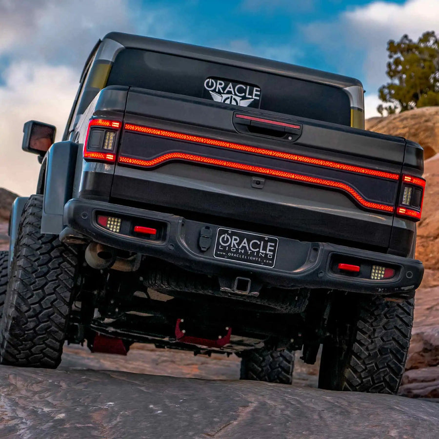 Rear view of a Jeep Gladiator JT equipped with Flush Mount LED Tail Lights and Racetrack LED Tailgate Panel.
