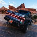 Rear end of a Jeep Gladiator JT equipped with Flush Mount Tail Lights, High Powered Reverse Lights, and Racetrack LED Tailgate Panel.