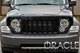 Front end of a Jeep Liberty with white LED headlight halo rings installed.