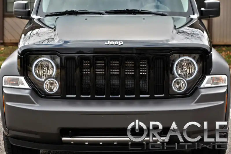 Front end of a Jeep Liberty with white LED headlight halo rings installed.