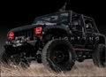 Three quarters view of a Jeep Wrangler JK with red LED headlight halo rings installed.
