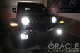 Black Jeep in a garage with bright LED headlights and fog lights