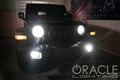 Black Jeep in a garage with bright LED headlights and fog lights