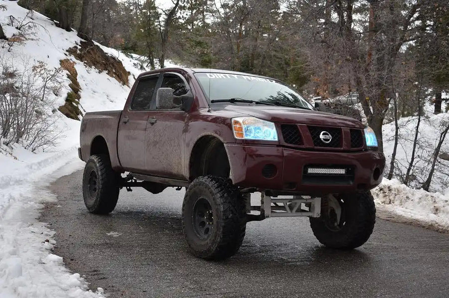 Three quarters view of a Nissan Titan with white LED headlight halo rings installed.