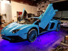 A baby blue Lamborghini with a purple LED underbody kit.