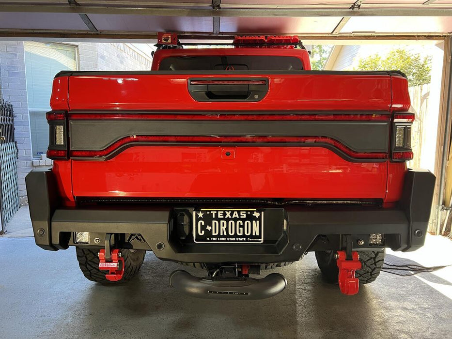 Red Jeep Gladiator in a garage with Racetrack Flush Style LED Tailgate Panel Light installed.