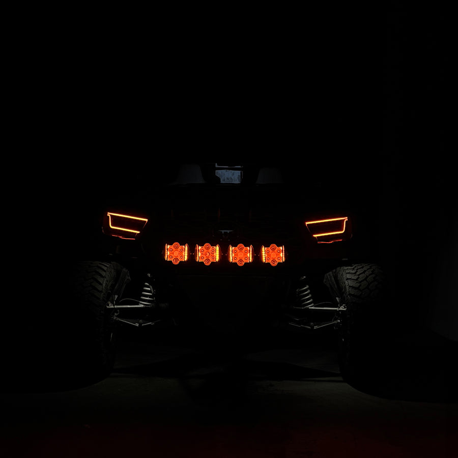 Front view of a vehicle with illuminated headlights in the dark
