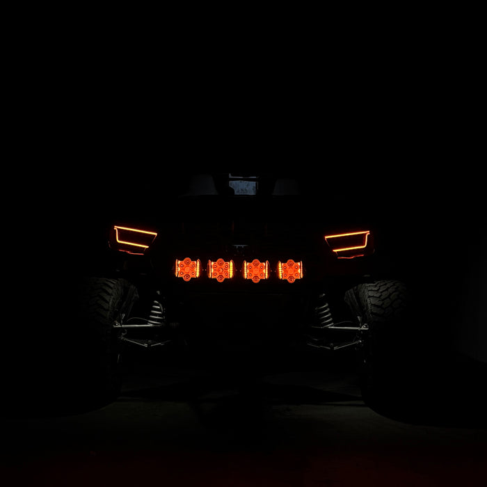 Front view of a vehicle with illuminated headlights in the dark