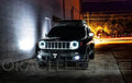 Three quarters view of a Jeep Renegade with white LED headlight halo rings installed.