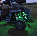 Polaris RZR outside with green rock lights installed.