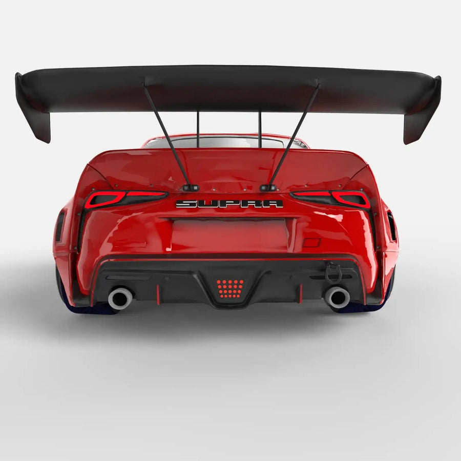 Rear view of a red Toyota Supra with Universal Illuminated LED Letter Badges installed above the license plate area.