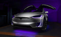 Silver Tesla Model X with purple headlight and fog light DRLs.