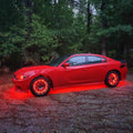 Red Dodge Charger with multiple ORACLE Lighting products installed, including wheel rings, halos, and underbody kit.