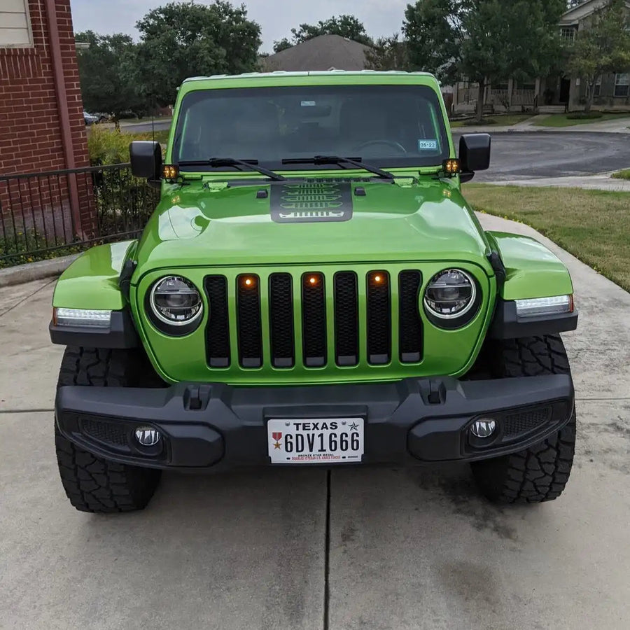 Front end of a green Jeep Gladiator JT with amber Pre-Runner Style LED Grill Light Kit installed.