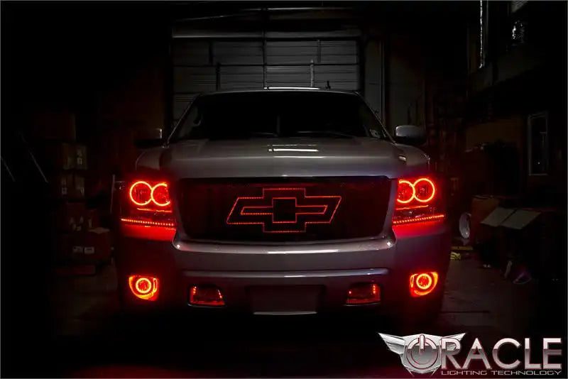 Front view of a Chevrolet Avalanche with red LED headlight and fog light halo rings installed.