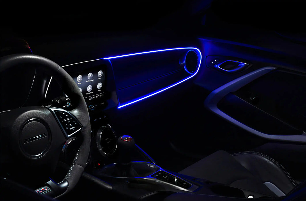 Car interior with blue fiber optic lighting installed on the dashboard.