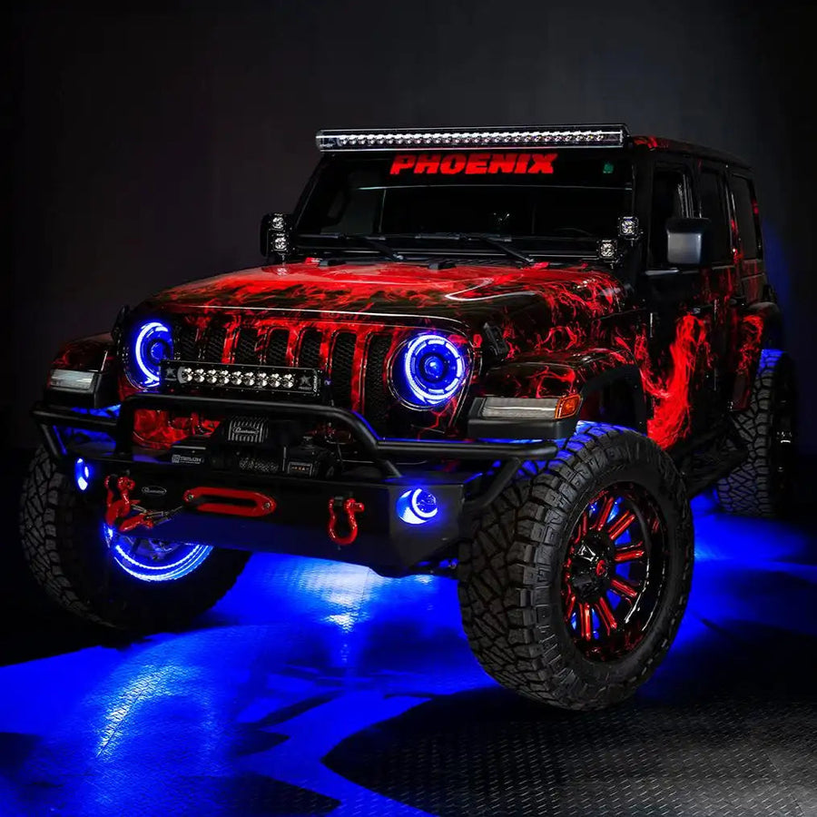 Three quarters view of a red Jeep Wrangler JL, with ColorSHIFT Oculus Headlights, and blue halo rings.