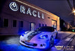 White Corvette parked outside ORACLE Lighting headquarters, fully equipped with blue LED lighting products.