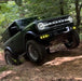 Ford Bronco riding on a trail with multiple LED lighting products installed.