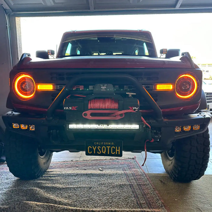 Front view of a red Ford Bronco with Oculus Headlights installed.