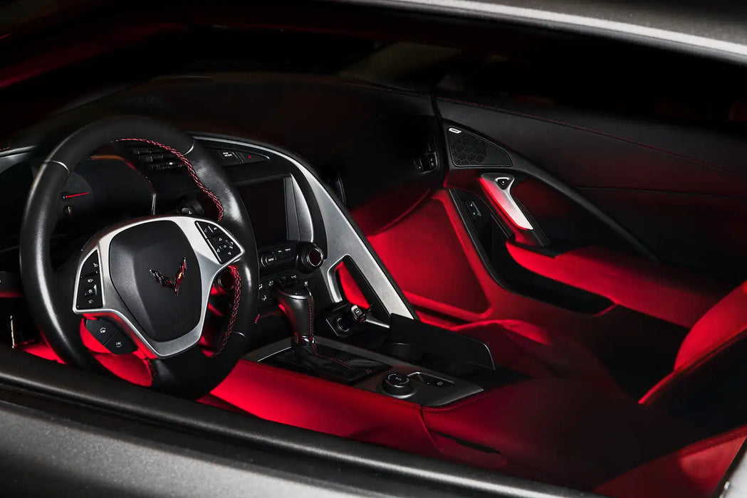 Car interior with red LED footwell lighting.