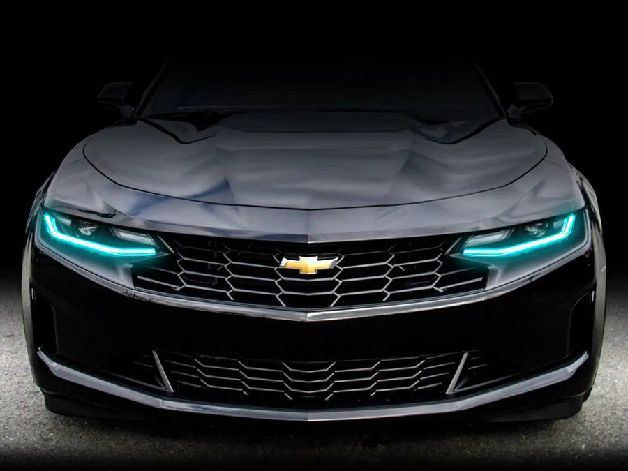 Front end of a Chevrolet Camaro with aqua headlight DRLs.