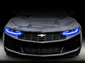 Front end of a Chevrolet Camaro with blue headlight DRLs.