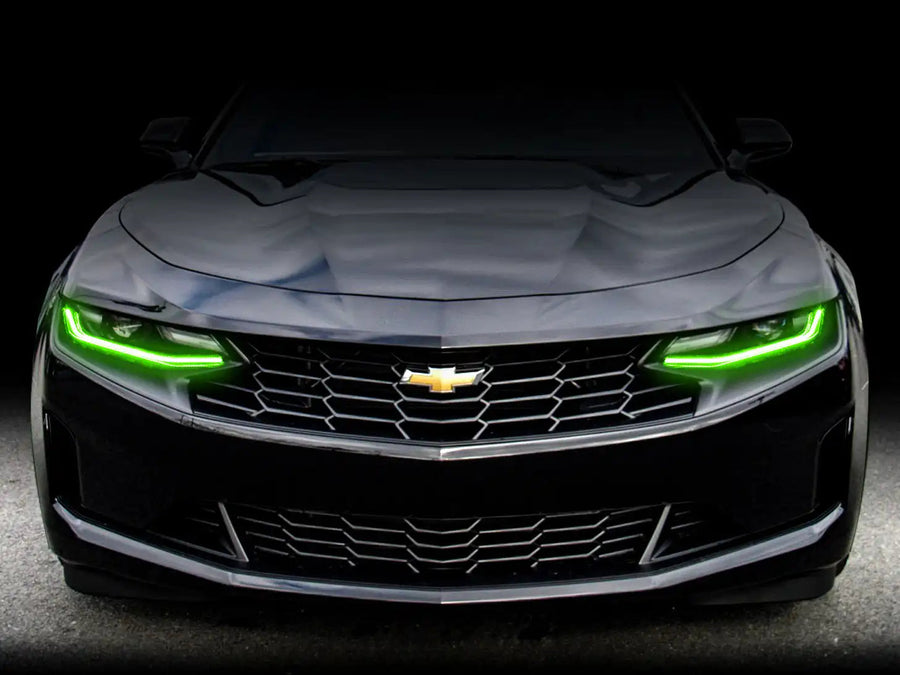 Front end of a Chevrolet Camaro with green headlight DRLs.
