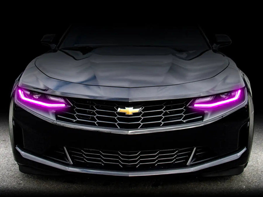 Front end of a Chevrolet Camaro with pink headlight DRLs.