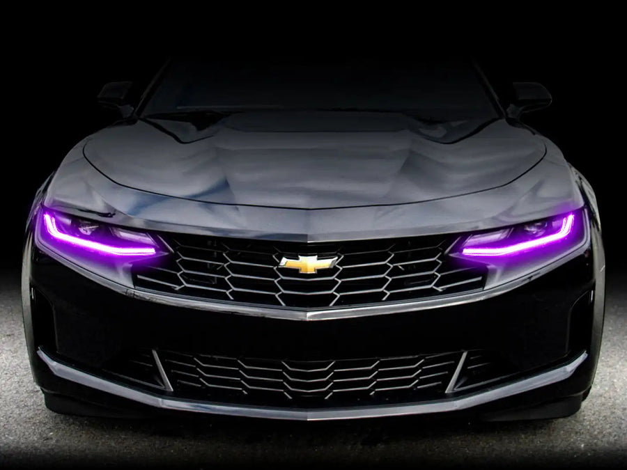 Front end of a Chevrolet Camaro with pink headlight DRLs.