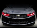 Front end of a Chevrolet Camaro with red headlight DRLs.