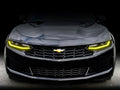 Front end of a Chevrolet Camaro with yellow headlight DRLs.