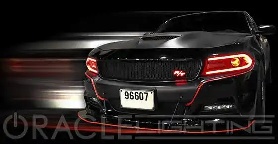 Front end of a black Dodge Charger with red headlight DRLs.