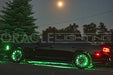 Side view of a black Charger with green LED wheel rings and underbody kit.