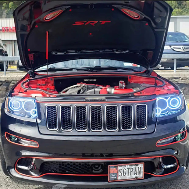 Front end of a Jeep Grand Cherokee with white LED headlight halo rings installed.